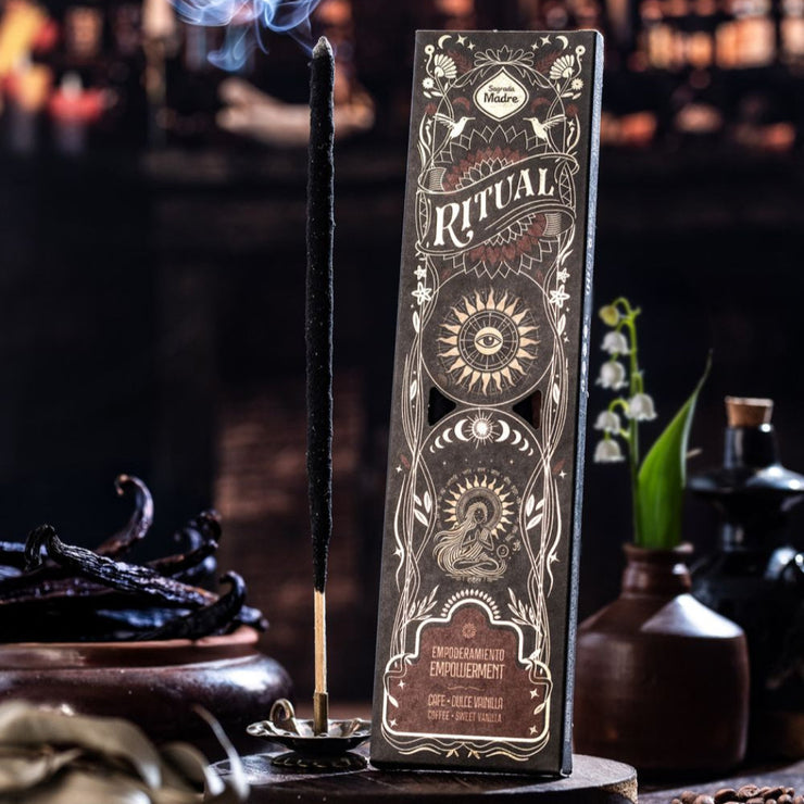 Decorative incense stick holder with intricate design on a dark background