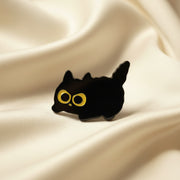 Black silhouette of a cat with yellow eyes on a white background