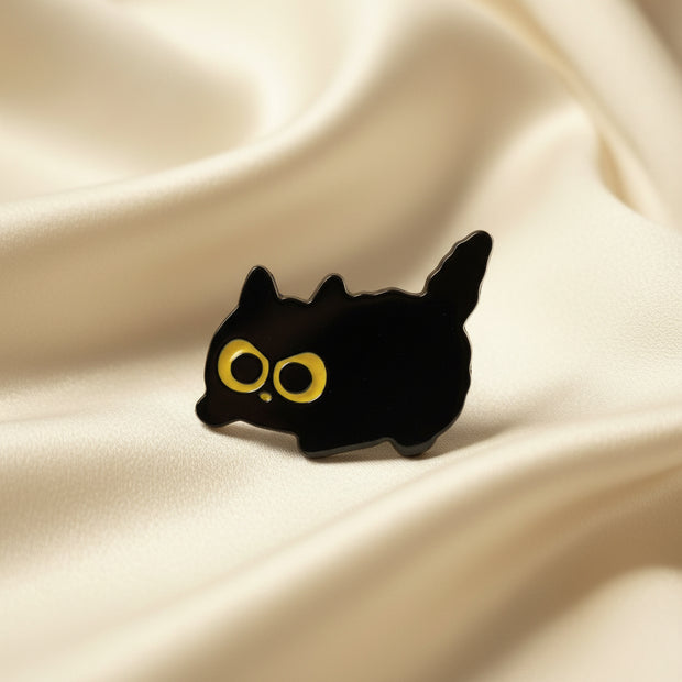 Black silhouette of a cat with yellow eyes on a white background