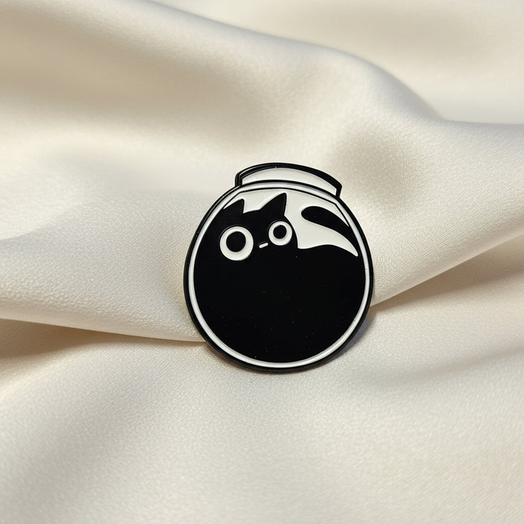 Black and white circular object with a cat silhouette on a beige surface