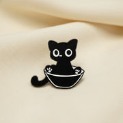 Black and white cat-shaped object on a light gray background