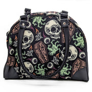 Gothic-style handbag with skull and candle design on a white background
