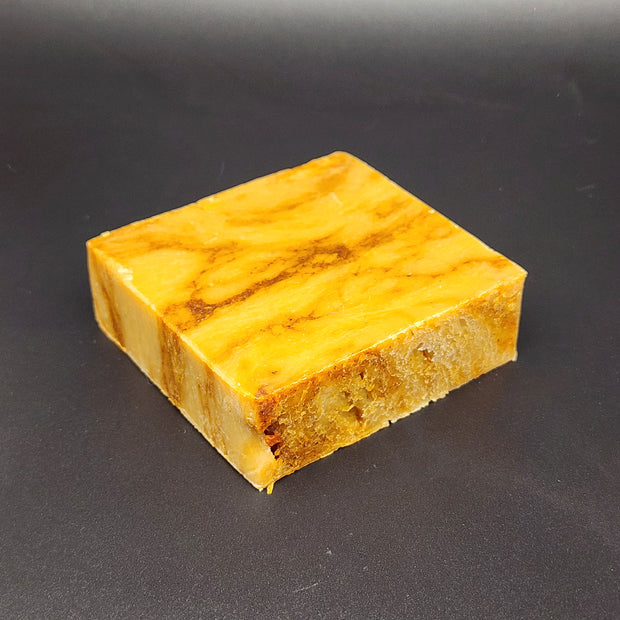 Yellow soap with brown patterns on a black background