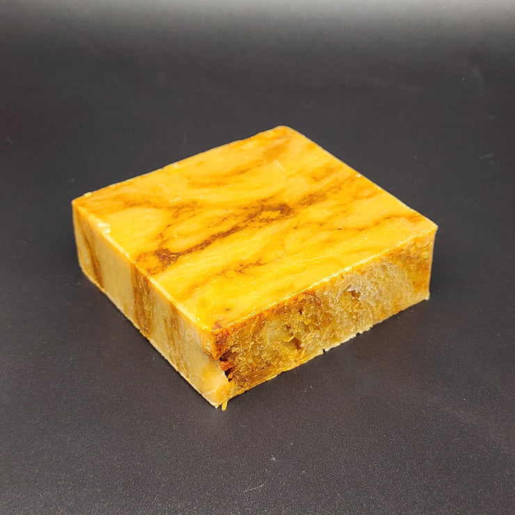 Yellow soap with brown patterns on a black background