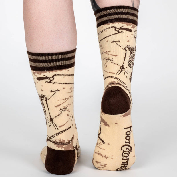 Vintage anatomy design socks with black and brown accents on a white background