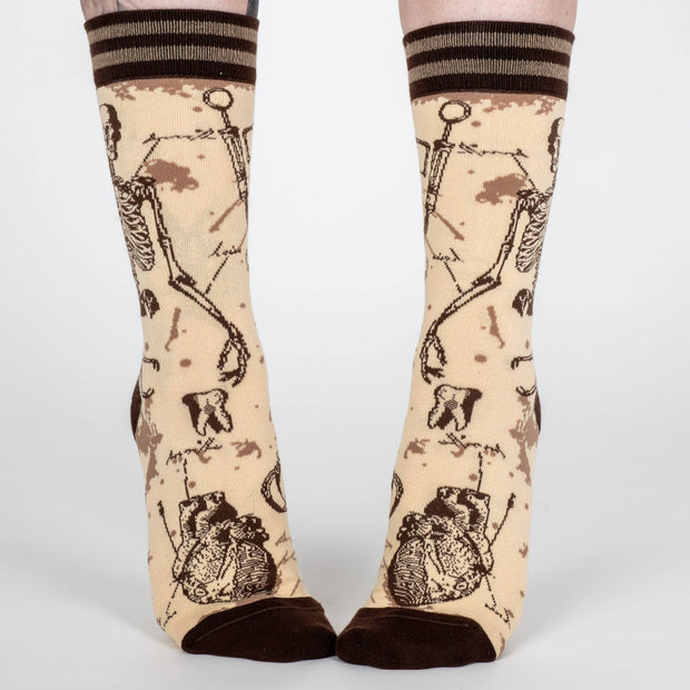 Socks with vintage-style illustrations of constellations on a beige background