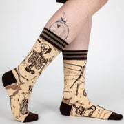 Socks with skeleton design worn by a person on a white background