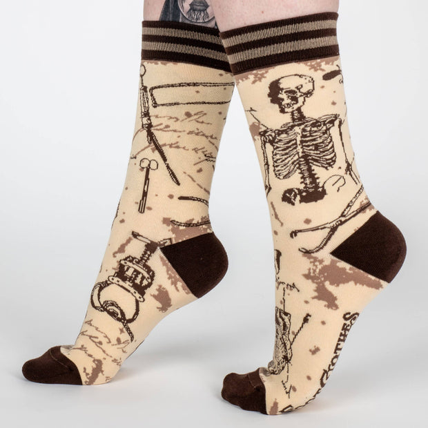 Socks with skeleton and medical tool design on a beige background