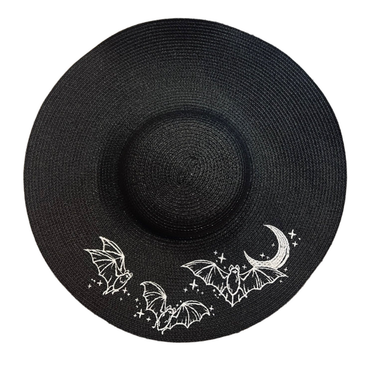 Black straw hat with white bat and moon designs on a white background