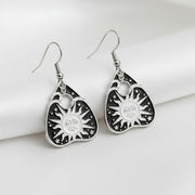 Pair of black and silver earrings on a gray background