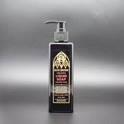 A black rectangular bottle of body wash with a pump top on a dark gray background
