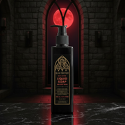 Black liquid soap bottle with gold label in a dark, gothic-style room with red glowing door.