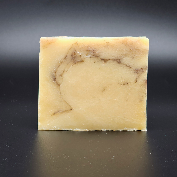 Bar of soap with a marbled pattern on a black background
