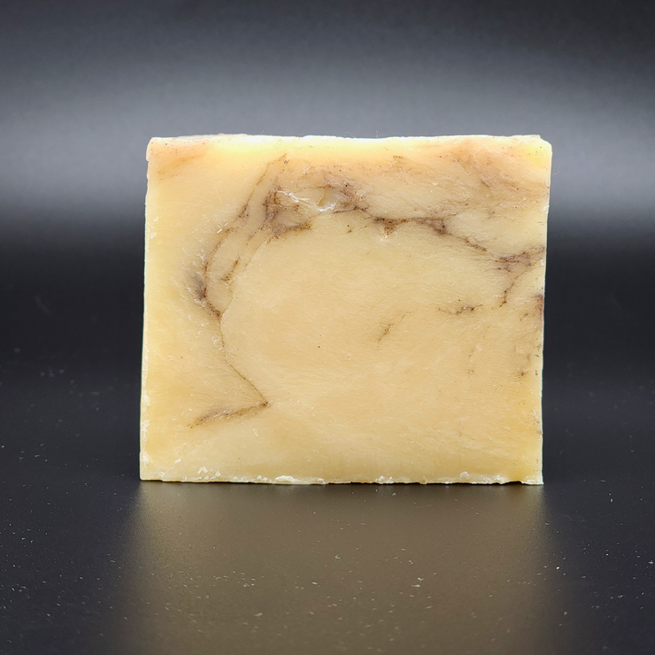 Bar of soap with a marbled pattern on a black background