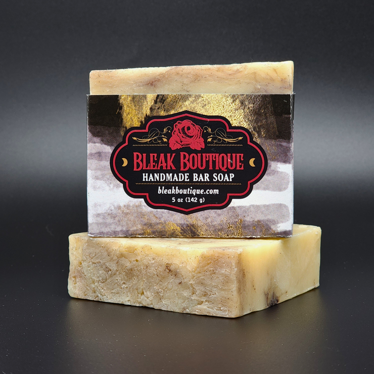 Handmade bar soap with a Bleak Boutique label on a dark background