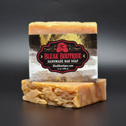 Handmade bar soap with a 'Bleak Boutique' label on a dark background