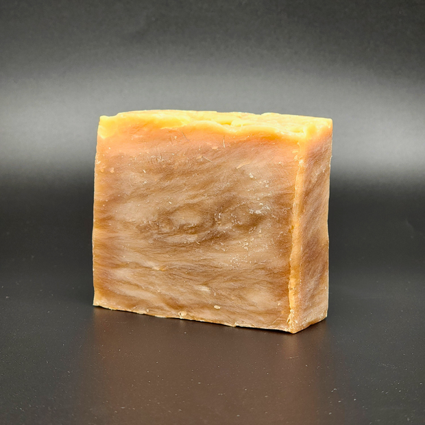 Bar of soap with a textured surface on a dark background