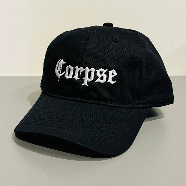 Black cap with 'Corpse' text on a light gray background