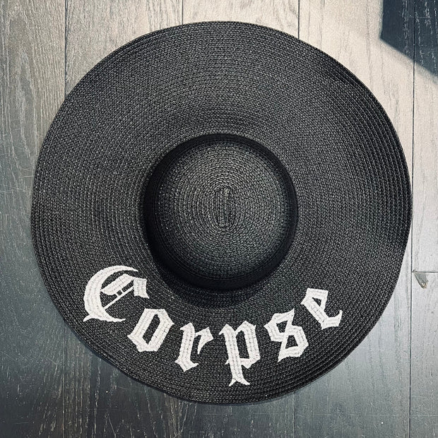 Black straw hat with 'Corpse' embroidery.