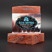 Bar of Cosmic Sea Handmade Bar Soap with a label detailing ingredients on a dark background, scent notes of Berries, Vanilla and Spice.