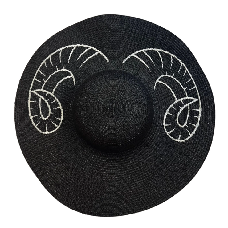 Black straw hat with white ram horns design on a white background