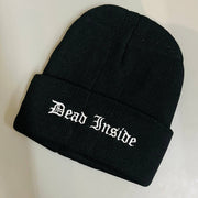 Black beanie with 'Dead Inside' text on a light gray background