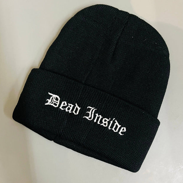 Black beanie with 'Dead Inside' text on a light gray background