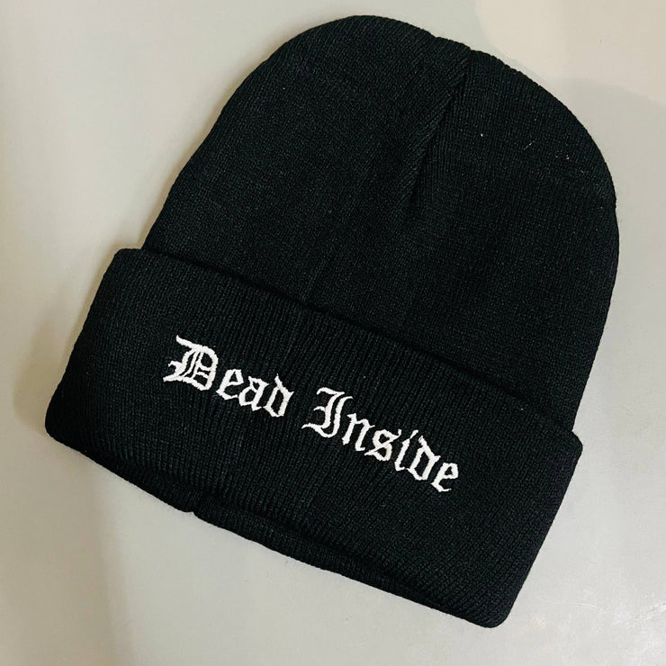 Black beanie with 'Dead Inside' text on a light gray background