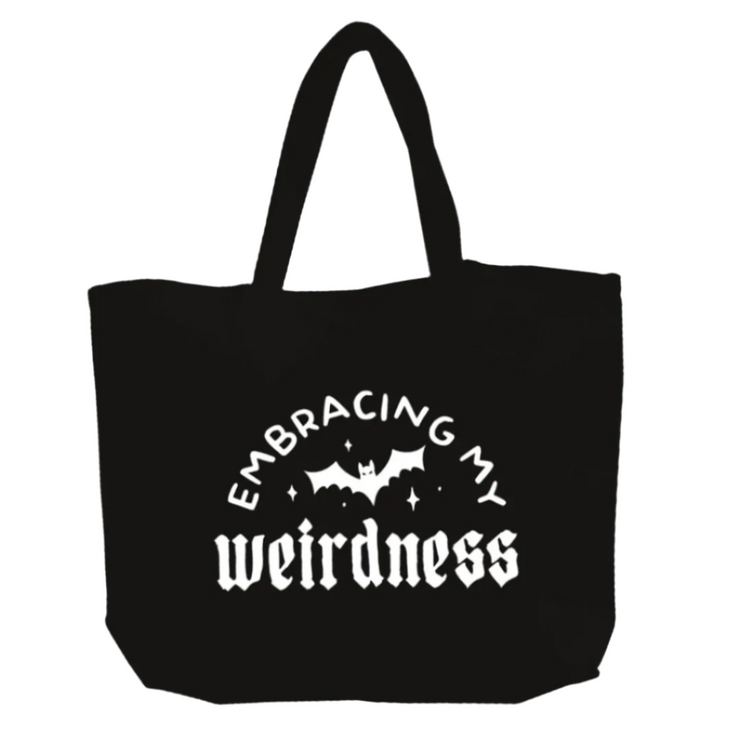 Black tote bag with white text 'Embracing my weirdness' and a bat graphic on a white background