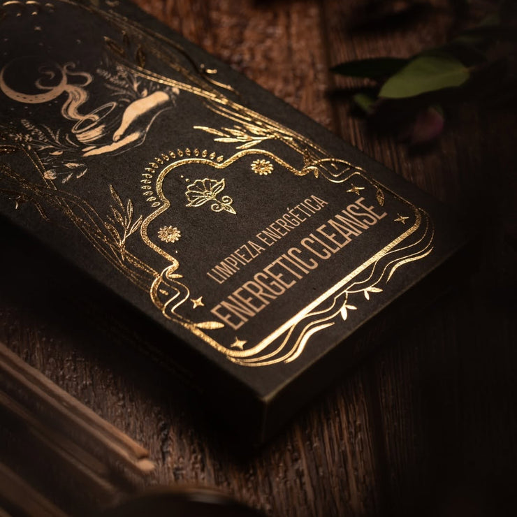Decorative black box with gold text on a wooden surface