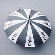 Umbrella with black and gray striped pattern and leaf designs on a gray background