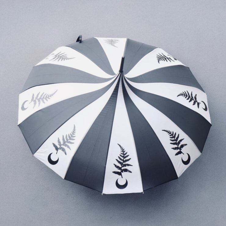 Umbrella with black and gray striped pattern and leaf designs on a gray background