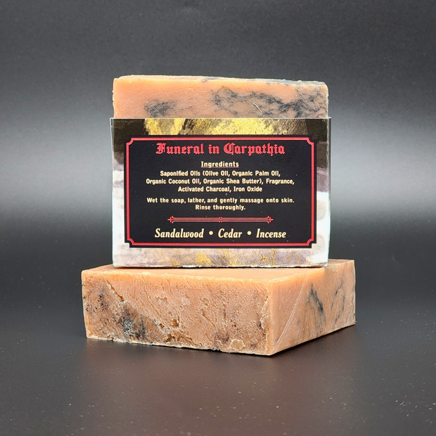 Two stacked soap bars with a label on a dark background