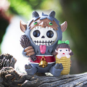 Toy figure of horned Krampus with a skeleton face, holding a child in a basket on a white background