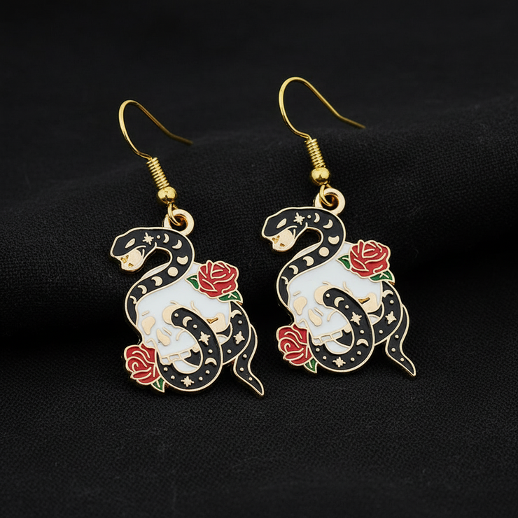 Snake and rose earrings on a black background