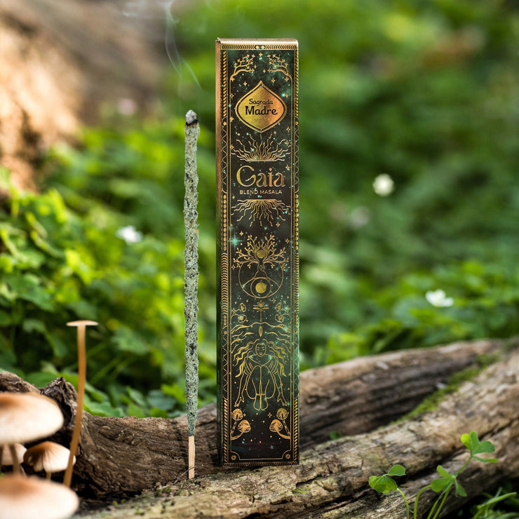 Incense stick with packaging on a wooden log in a natural setting