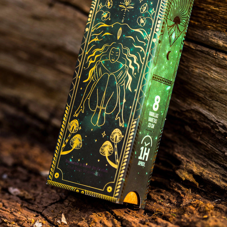 Decorative incense box with astrological design on a wooden surface