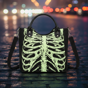 Handbag with skeleton design on a cobblestone street in a city center at night