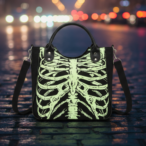 Handbag with skeleton design on a cobblestone street in a city center at night