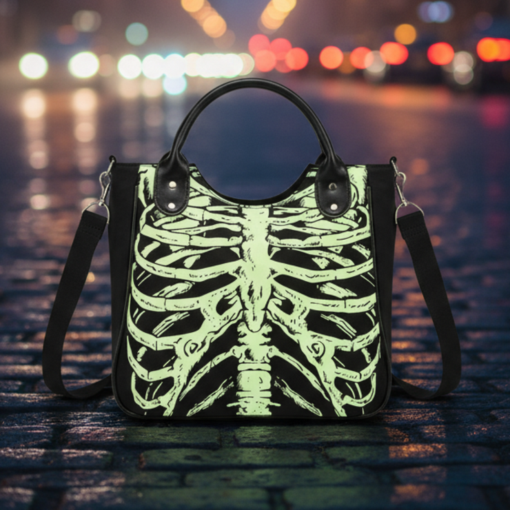 Handbag with skeleton design on a cobblestone street in a city center at night