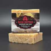 Handmade bar soap with Bleak Boutique label on a dark background