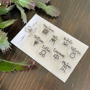 The Writual Planner Sabbat Stamps: Mark the Magic of the Wheel of the Year set features clear stamps with pagan holiday names and symbols—ideal for tracking seasonal celebrations in your tarot journal. Includes a green succulent leaf accent in the top left corner.