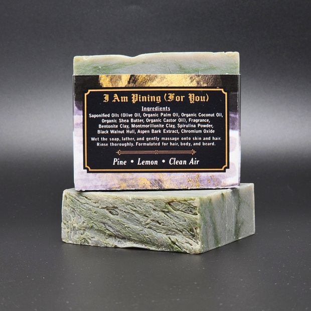 Bar of soap on a green marble stand with a label on a black background