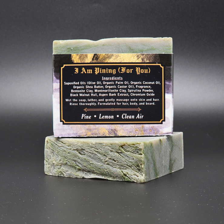 Bar of soap on a green marble stand with a label on a black background