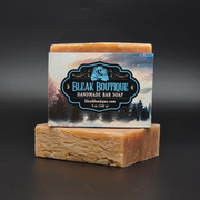 Handmade bar soap with Bleak Boutique label on a dark background