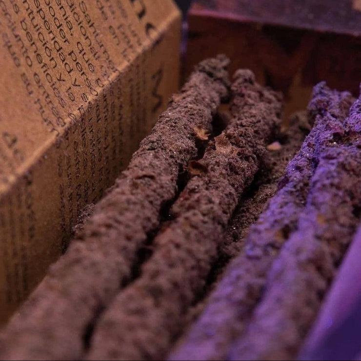 Close-up of incense sticks with a blurred box in the background