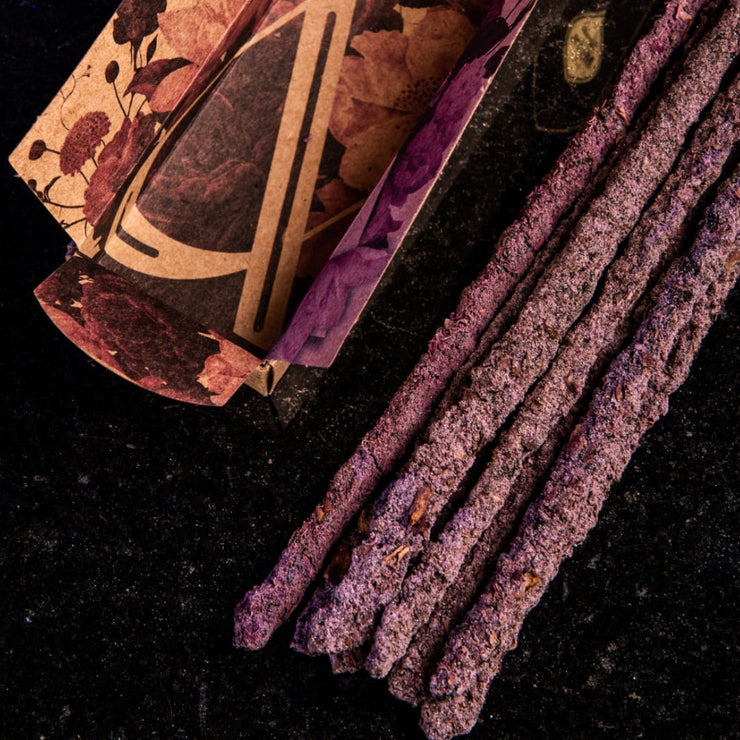 Purple sticks with a decorative box on a dark background