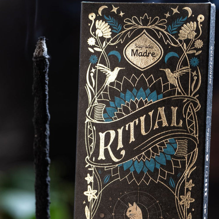 Decorative packaging with 'Ritual' branding and intricate designs on a dark background.