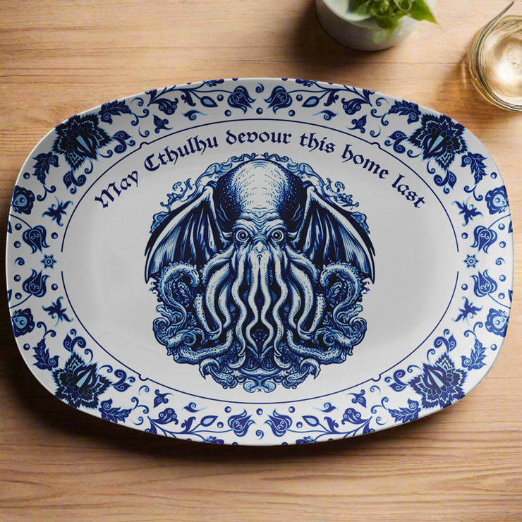 Decorative plate with blue Cthulhu design and text on a wooden surface