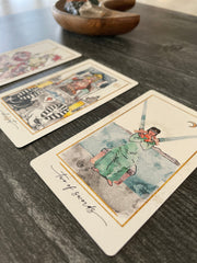 Vintage-style tarot cards on a wooden surface
